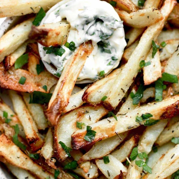Crispy oven baked French fries with fresh herbs and garlic seasoning