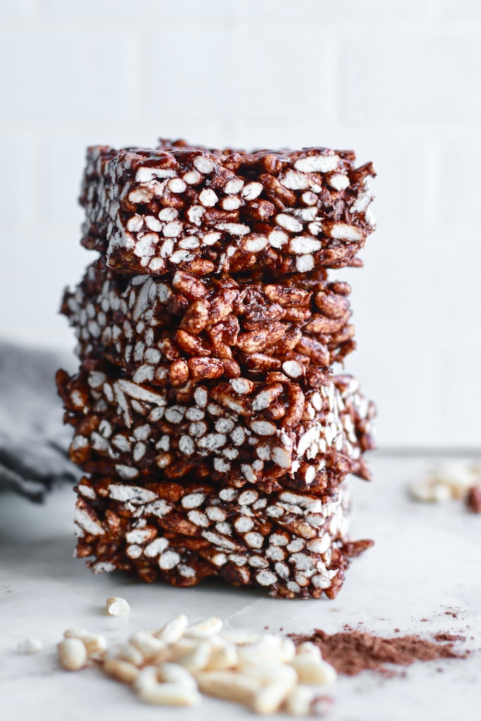 healthy rice krispie treats with cocoa stacked on each other