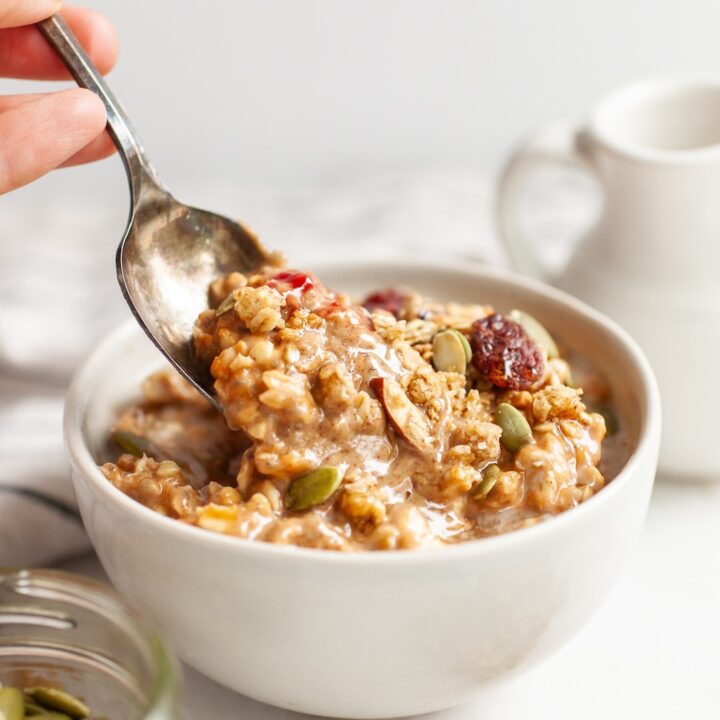 Spoon scooping a bite of Pumpkin Spice Overnight Oats out of a bowl