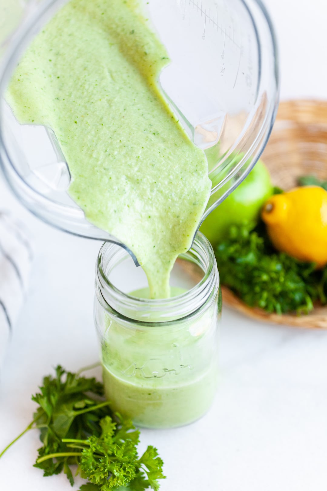 Pouring Best Ever Parsley Smoothie Recipe into a Jar
