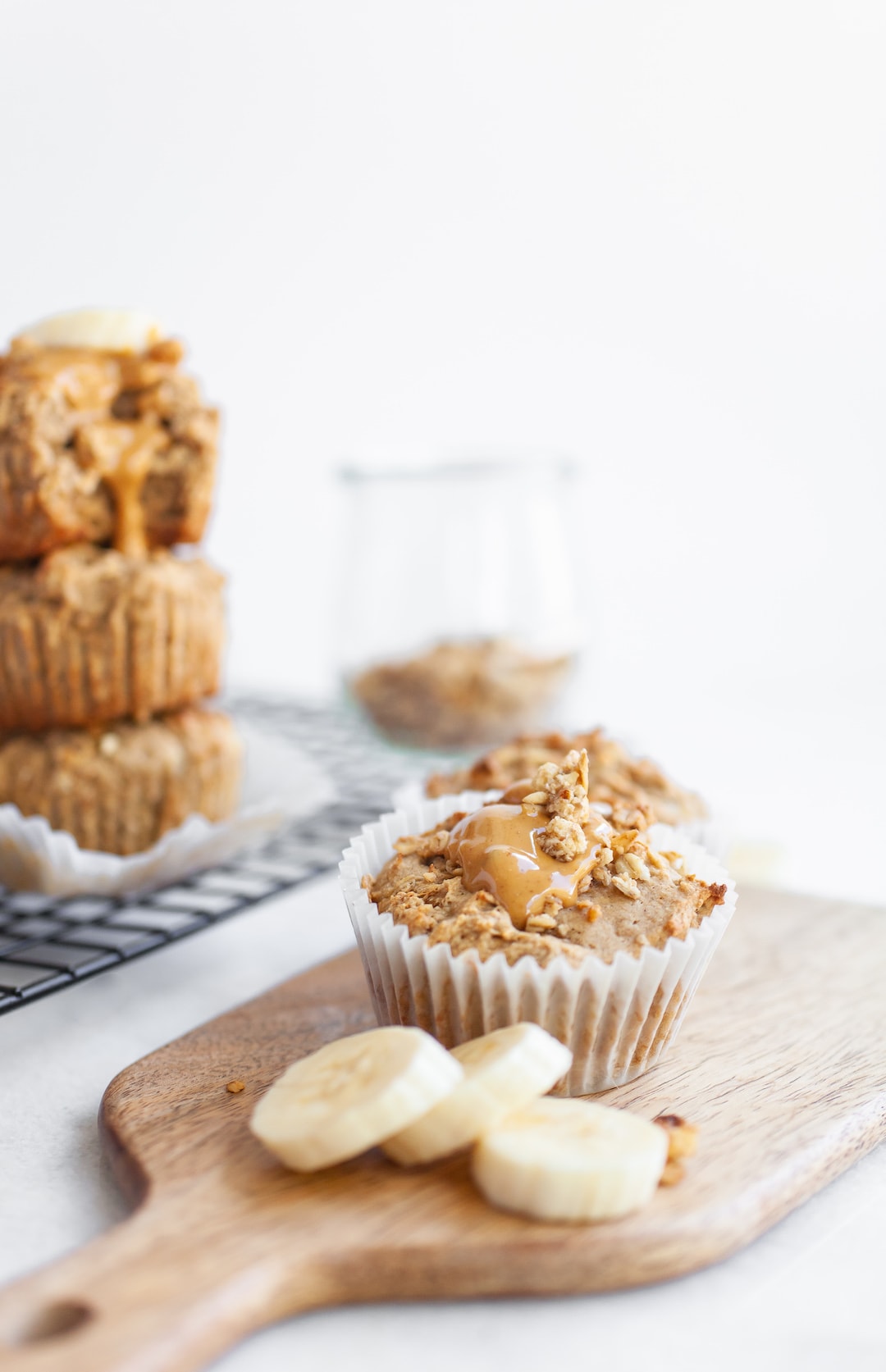 banana muffins on a wood tray with banana slices
