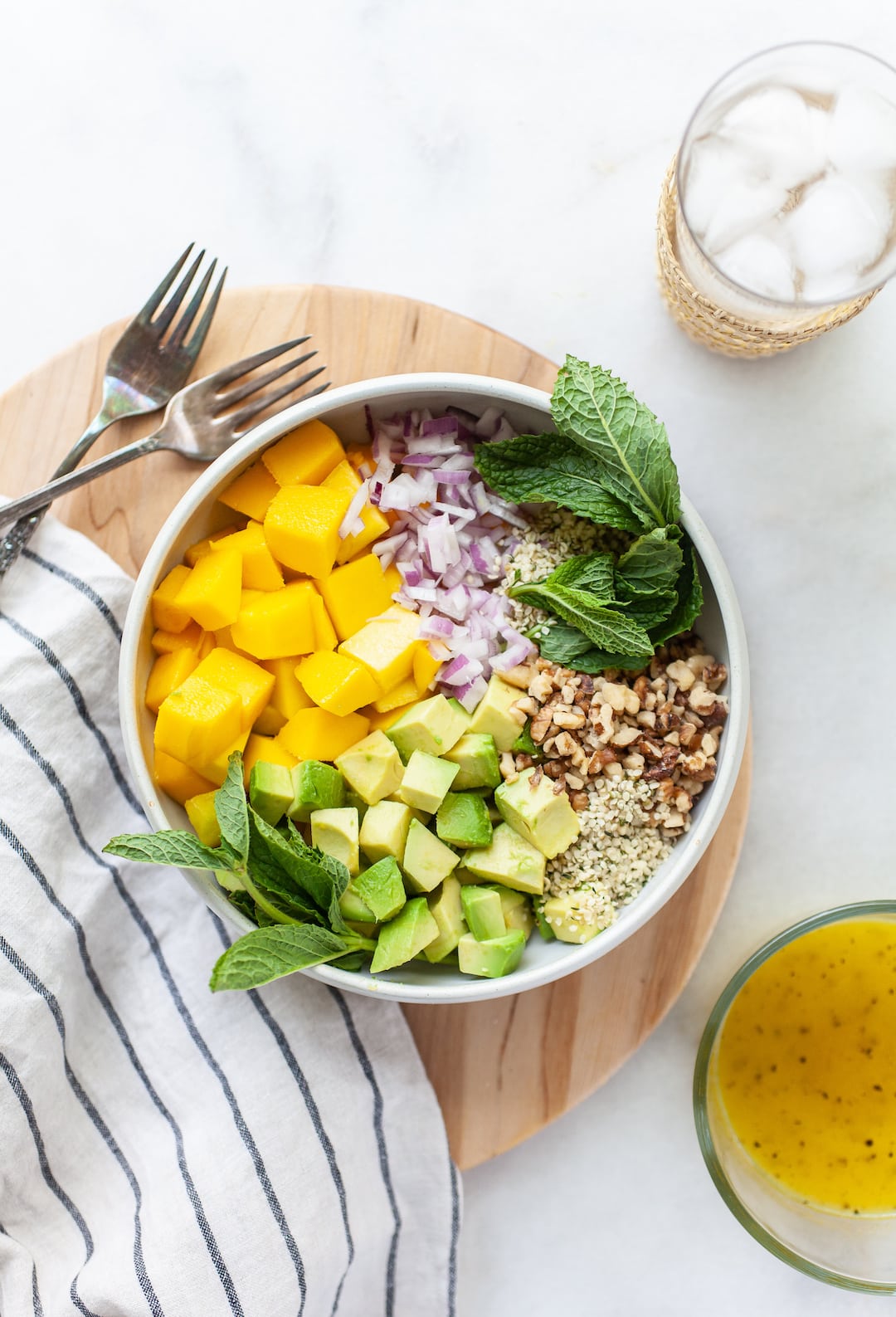 Overhead view of a bowl with Easy Mango Avocado Salad ingredients before mixing