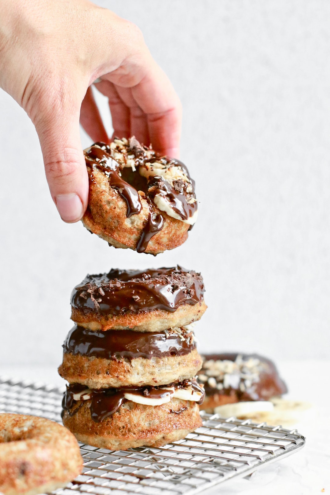 Stacked healthy banana bread donuts with chocolate glaze - plant based