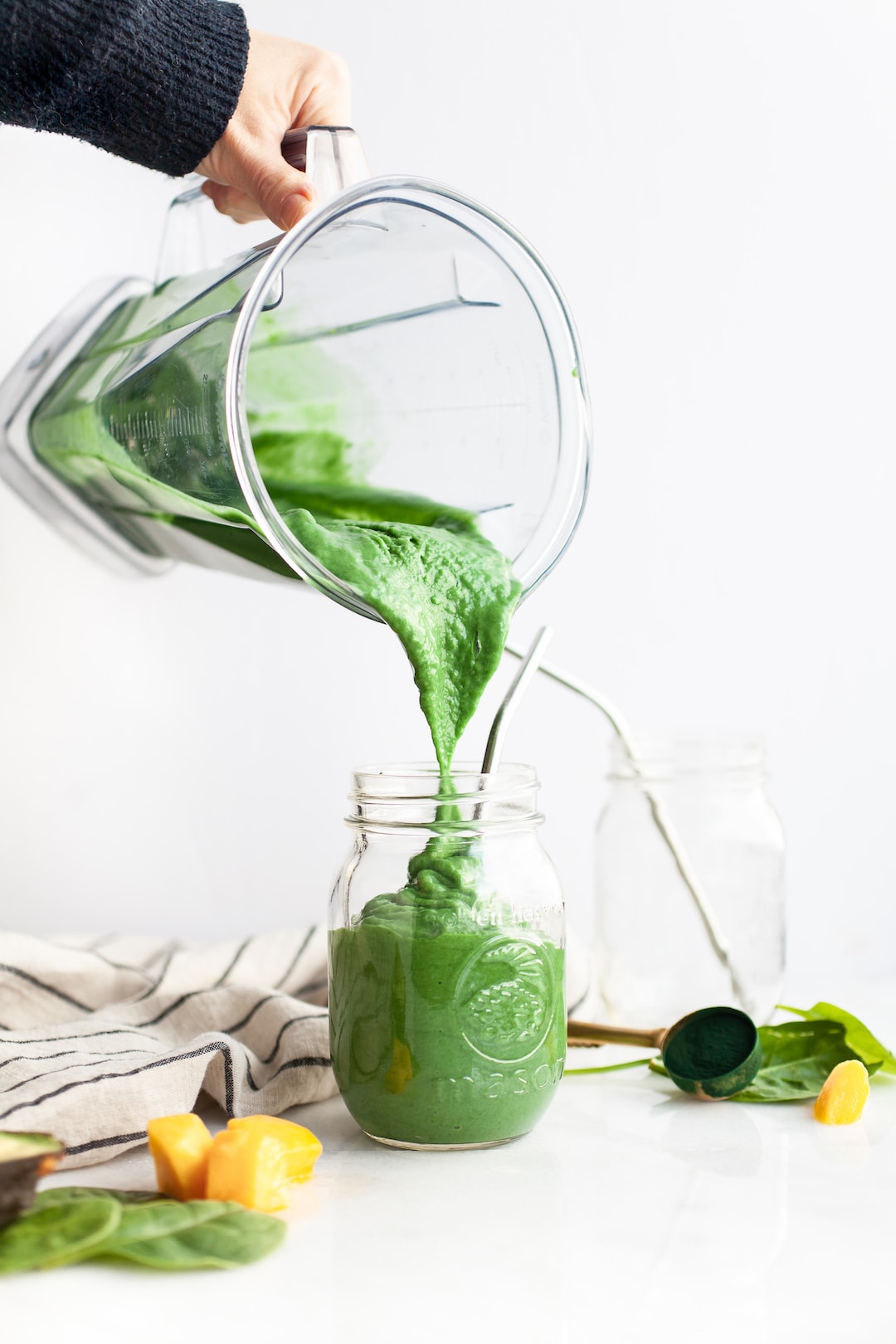 The Best Green Spirulina Smoothie Pouring into a jar