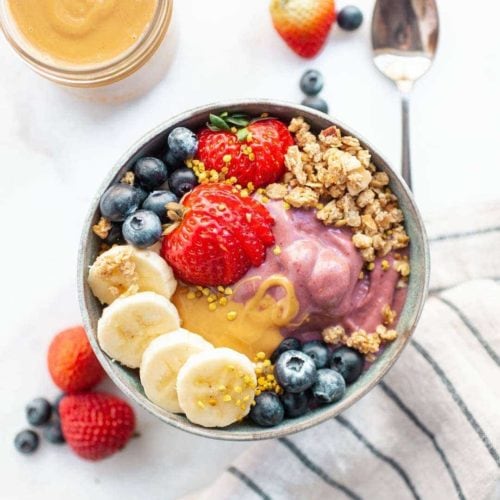 Learn how to make the best peanut butter acai bowl recipe that’s healthy, vegan, easy, and made with frozen acai berry! This Hawaii favorite can now be homemade in your own kitchen and its amped up with protein powder for extra nutrition!
