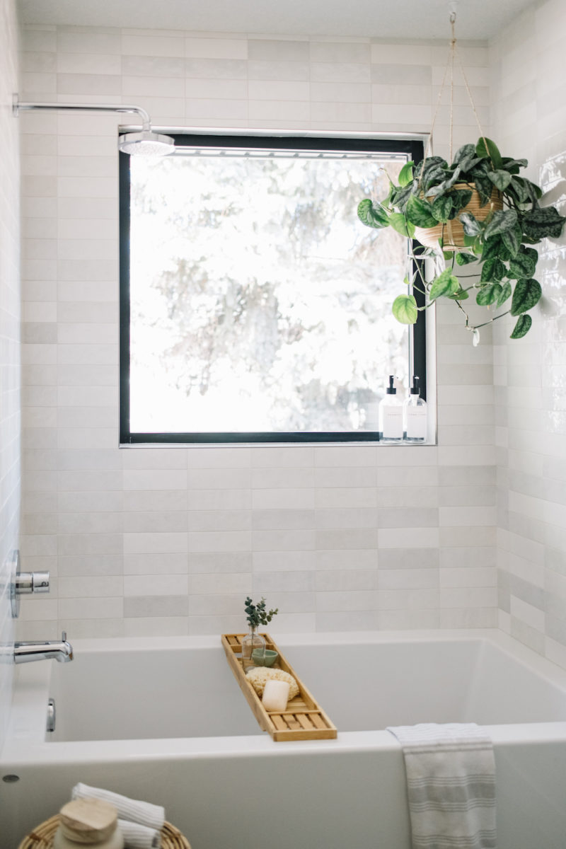 bathroom with light grey artisan tile and hanging plant