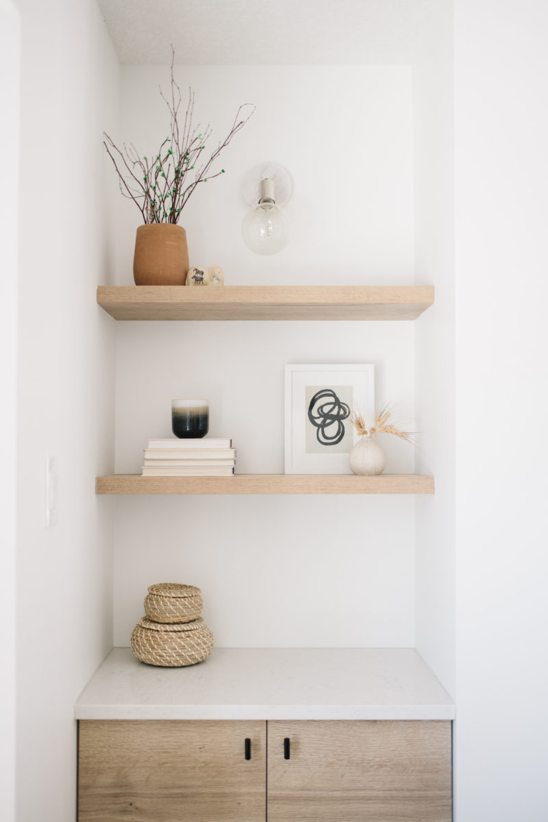 natural wood floating shelves with neutral decor