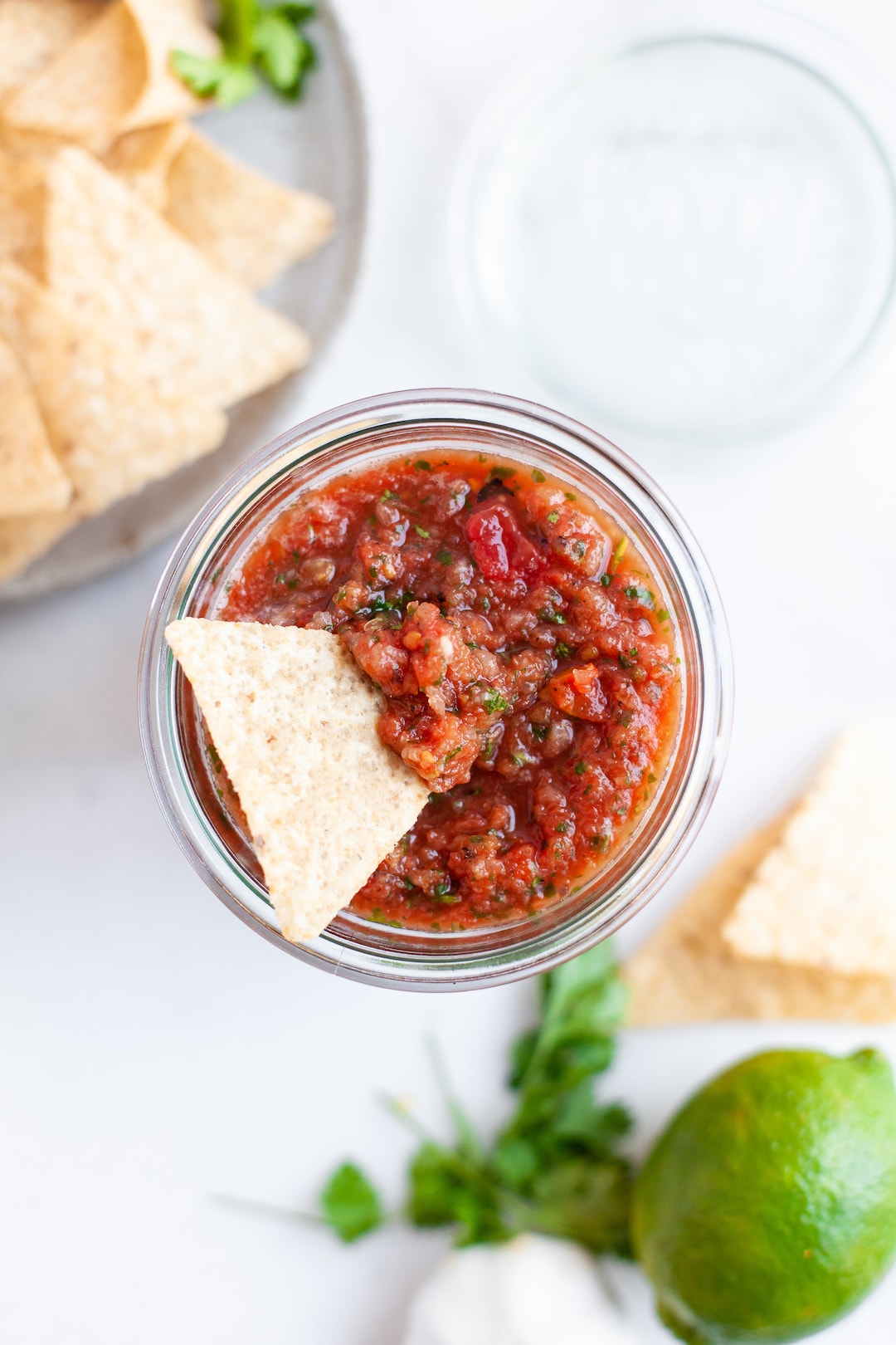 homemade salsa in a jar with tortilla chip
