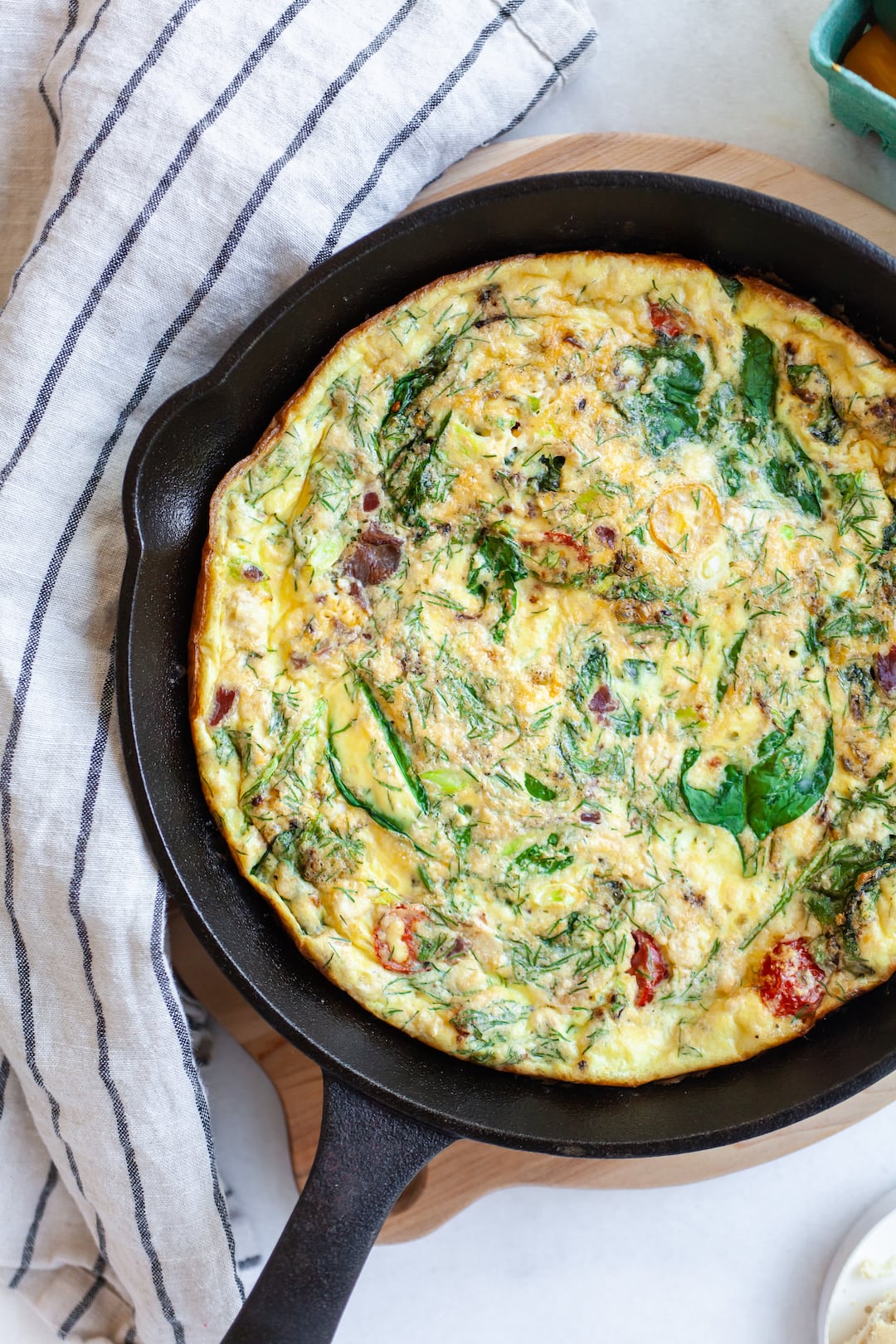 Cooked frittata in a skillet with vegetables