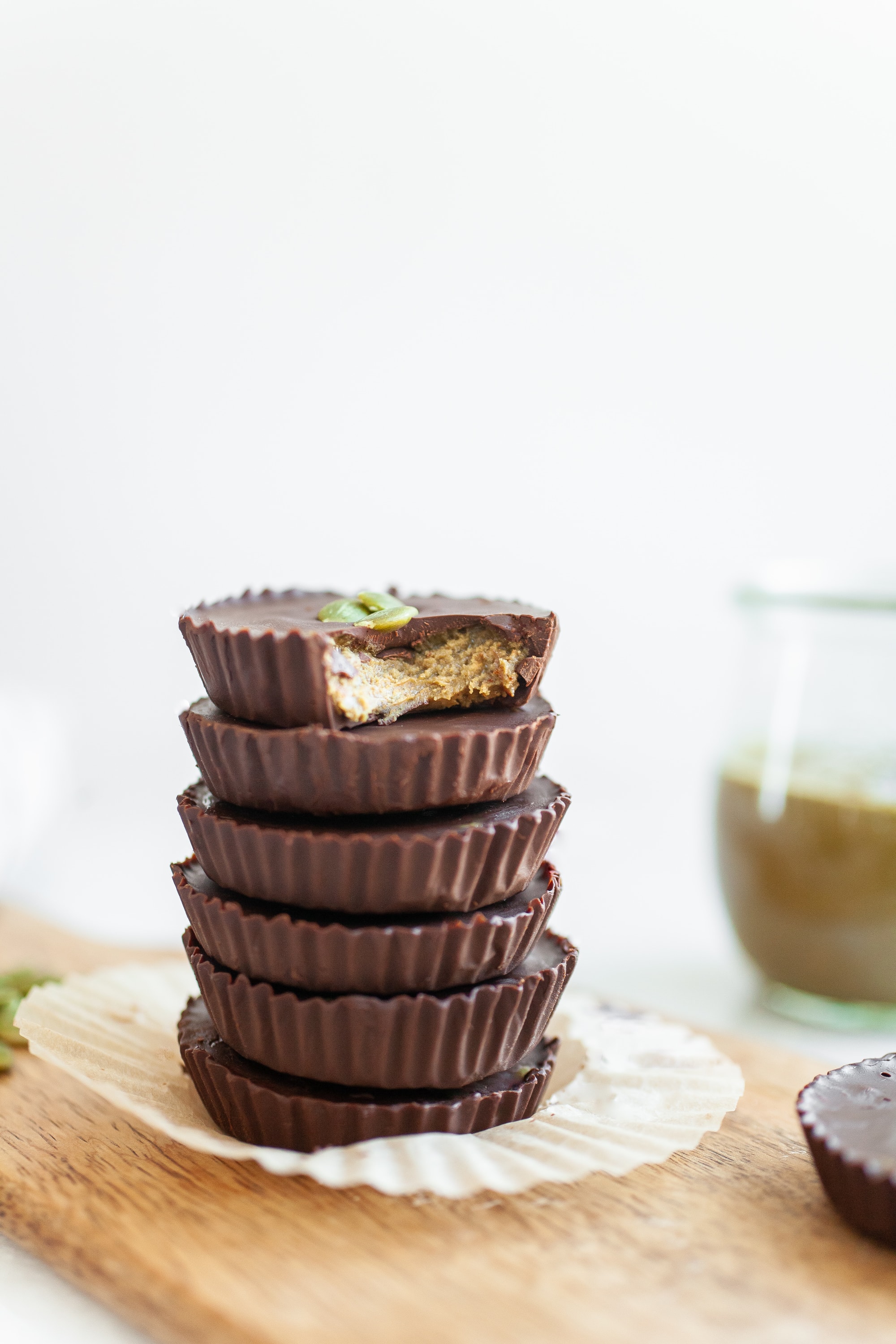 stack of pumpkin seed butter cups covered in chocolate
