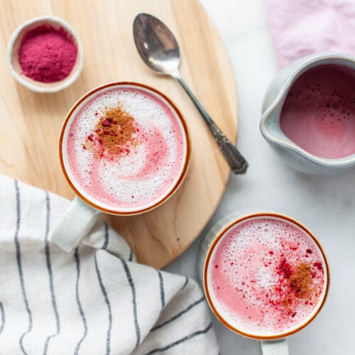 Pink beet lattes in two mugs