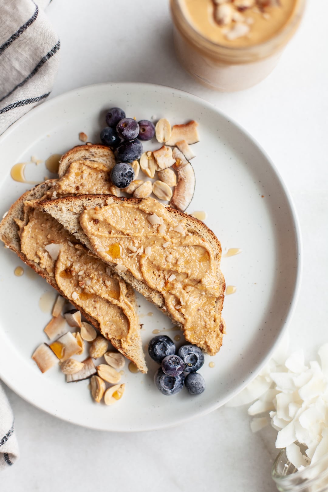Toast topped with coconut peanut butter and blueberries
