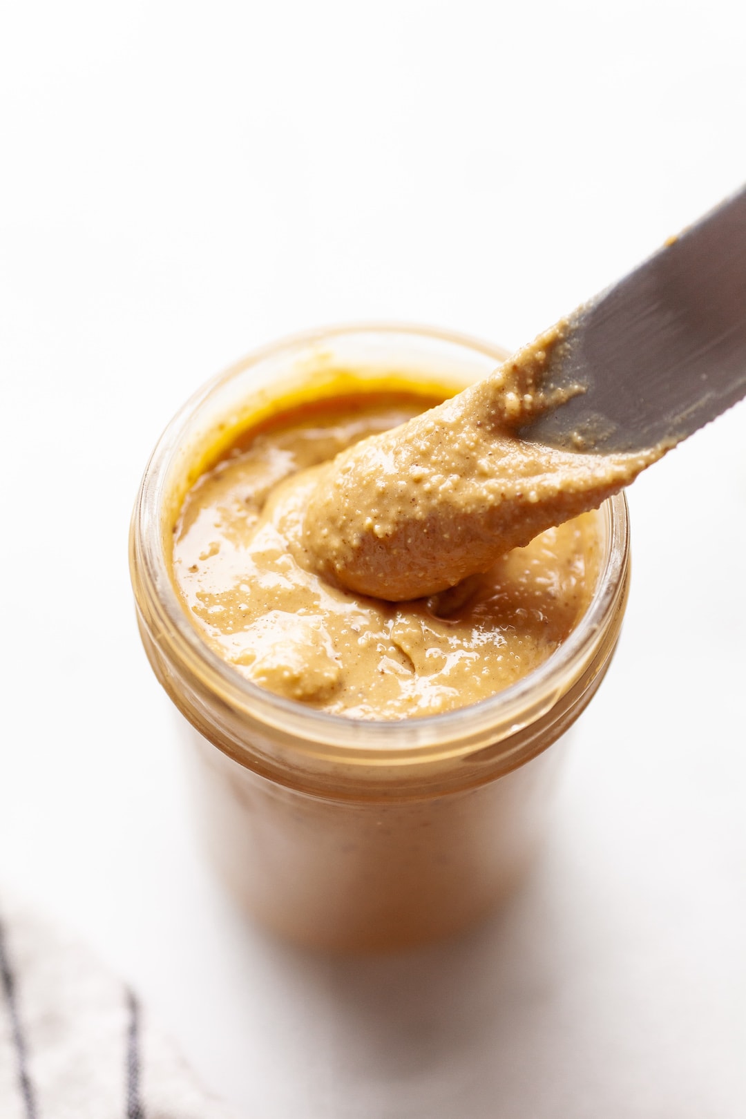 Jar of coconut peanut butter with a knife
