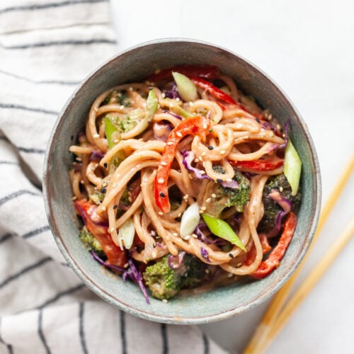 Peanut sauce noodle stir fry with vegetables in a bowl