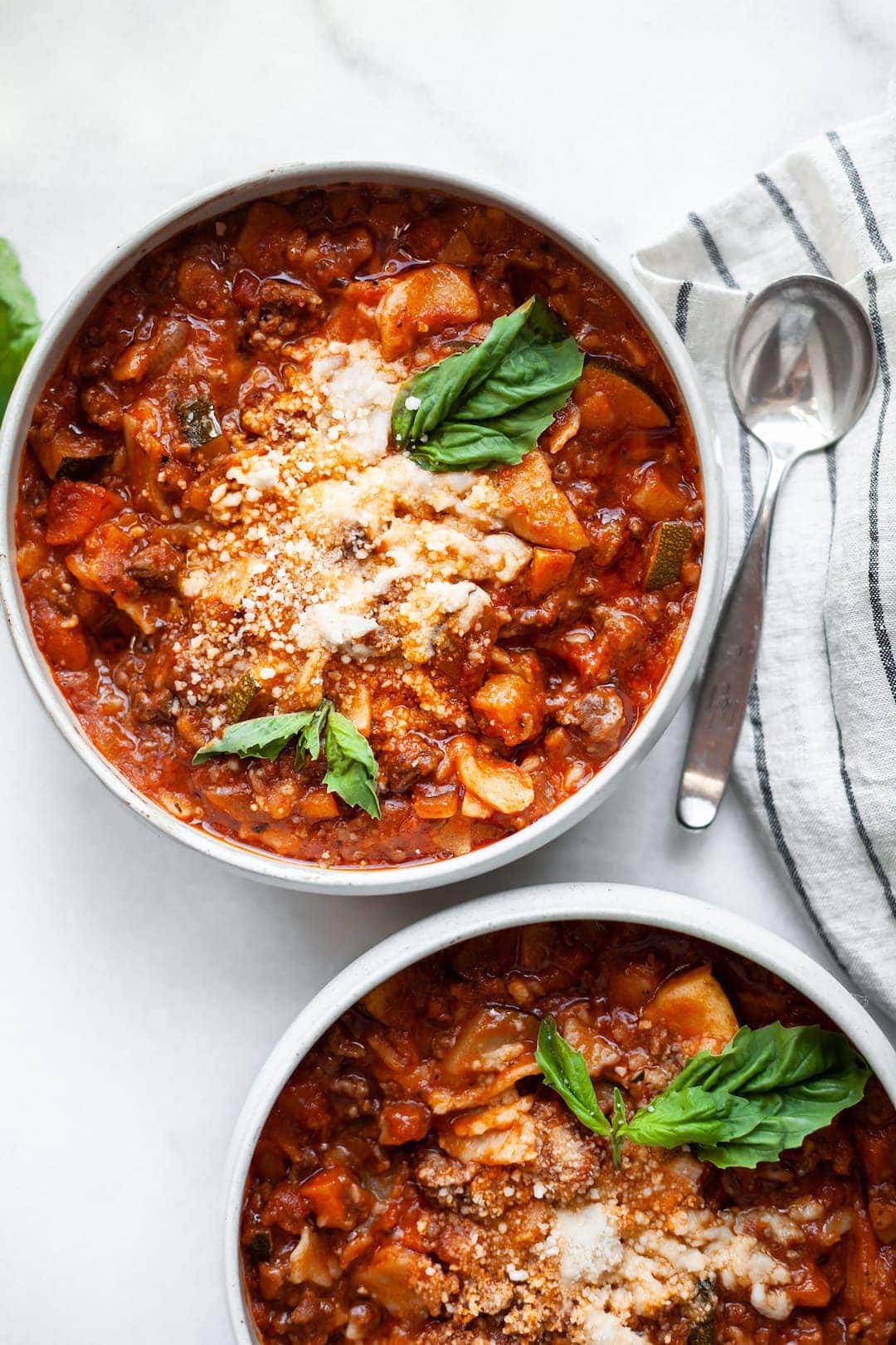 Slow Cooker Lasagna Soup in two bowls garnished with basil