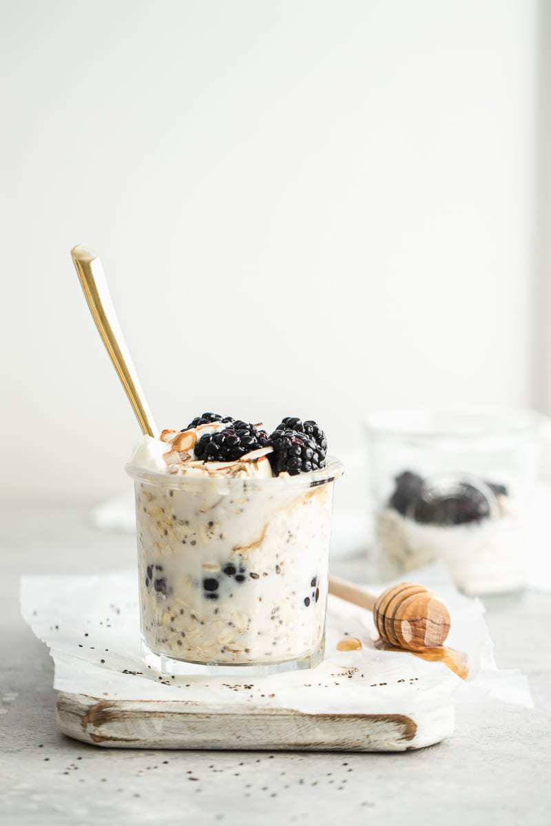 Jar of vanilla overnight oats topped with blackberries