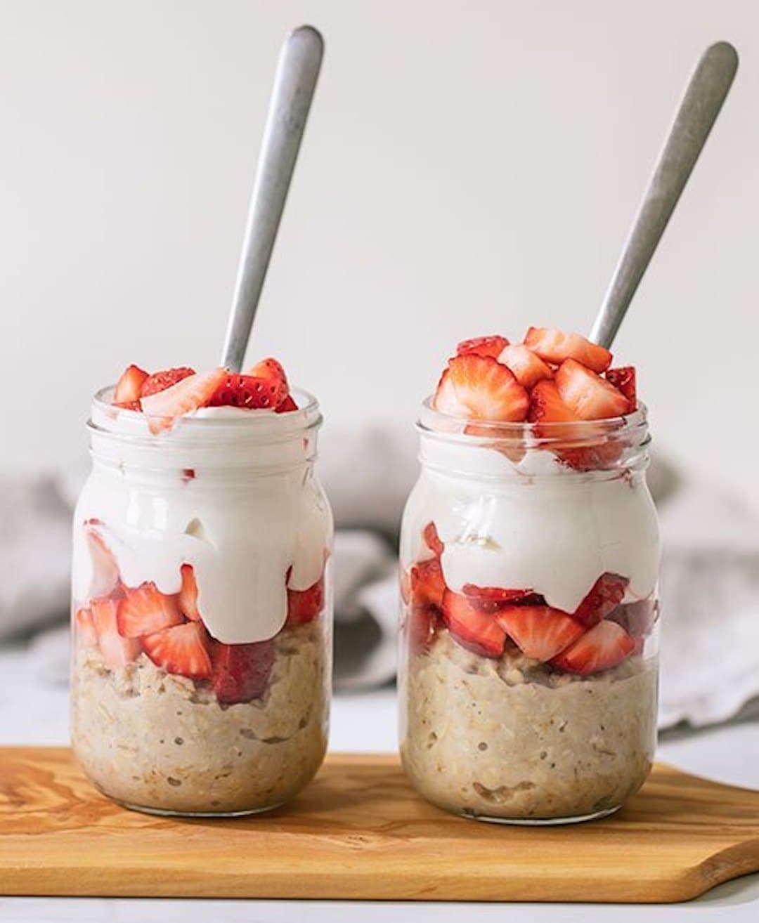 Strawberry overnight oats layered with yogurt in a jar