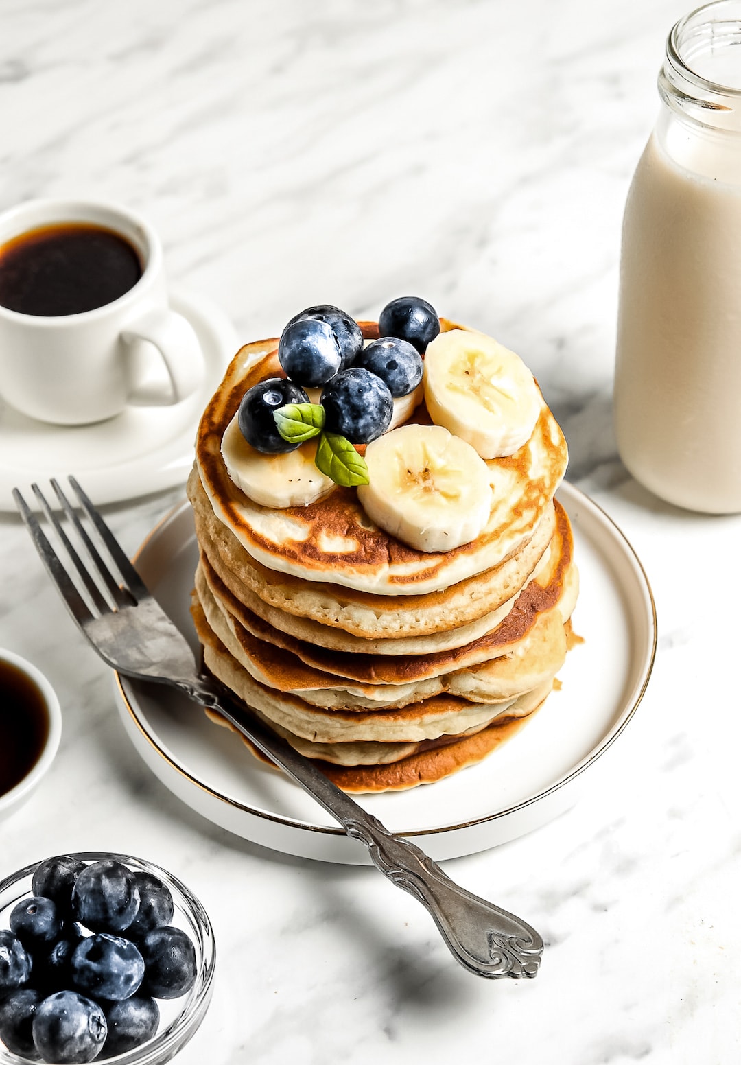 Stack of Healthy Cassava Flour Pancakes topped with blueberries and banana