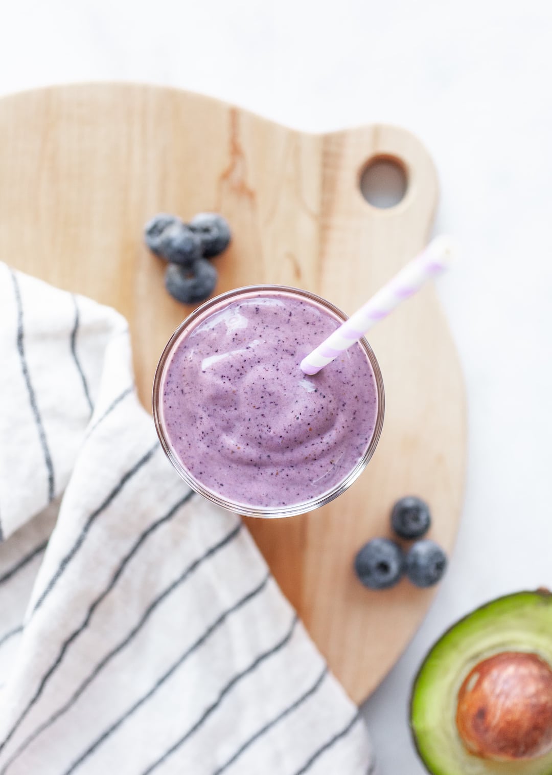 Overhead view of Creamy Blueberry Avocado Smoothie in a glass