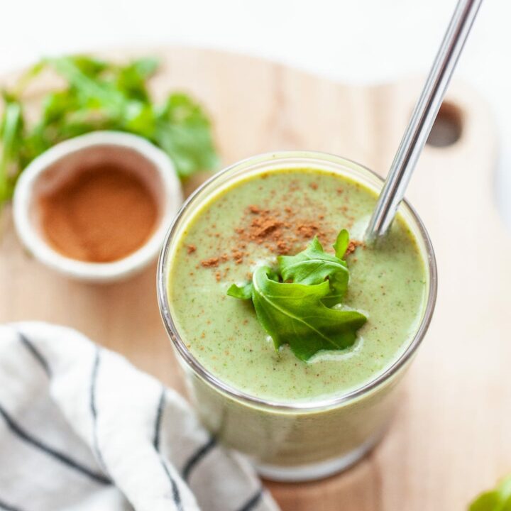 Delicious Arugula Smoothie Recipe in a glass topped with fresh arugula