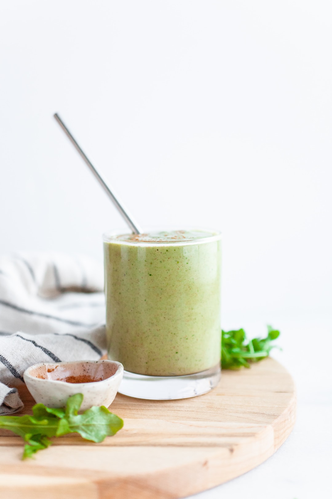Delicious Arugula Smoothie Recipe in a glass with a metal straw