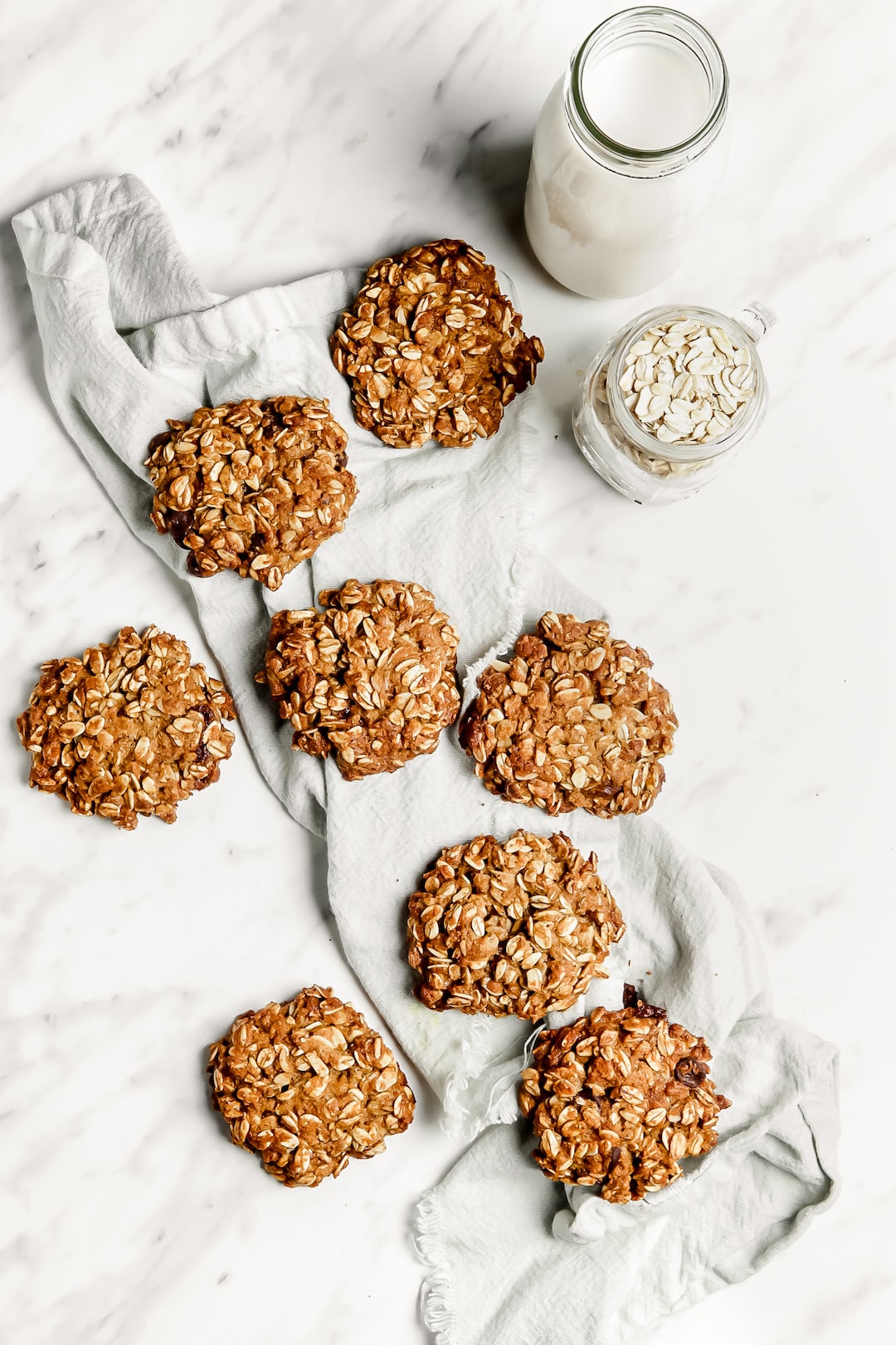 Soft Healthy Almond Flour Oatmeal Cookies on a marble board with tea towel