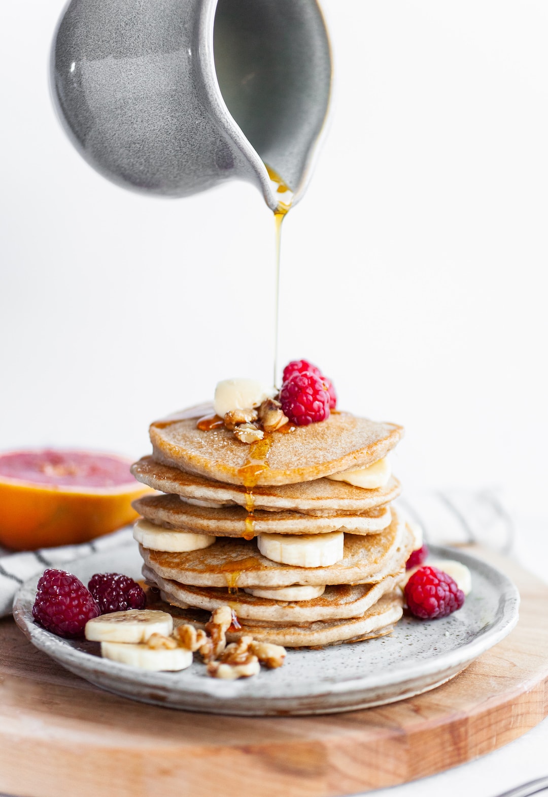 Maple syrup pouring on Perfect Vegan Buckwheat Pancakes