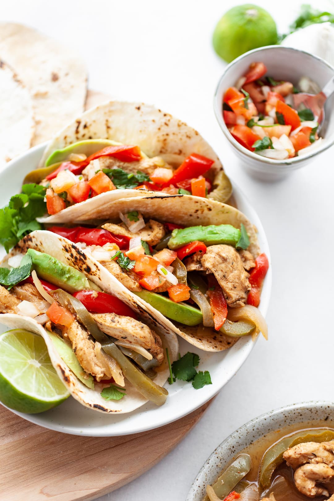 Instant Pot Chicken Fajitas on a plate with fresh salsa and avocado