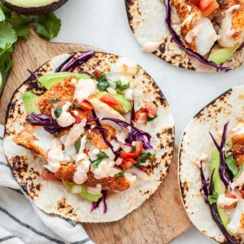 Overhead shot of Healthy Air Fryer Fish Tacos with spicy aioli drizzle