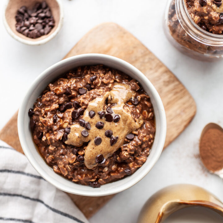 Bowl of Healthy Chocolate Overnight Oats with almond butter and chocolate chips