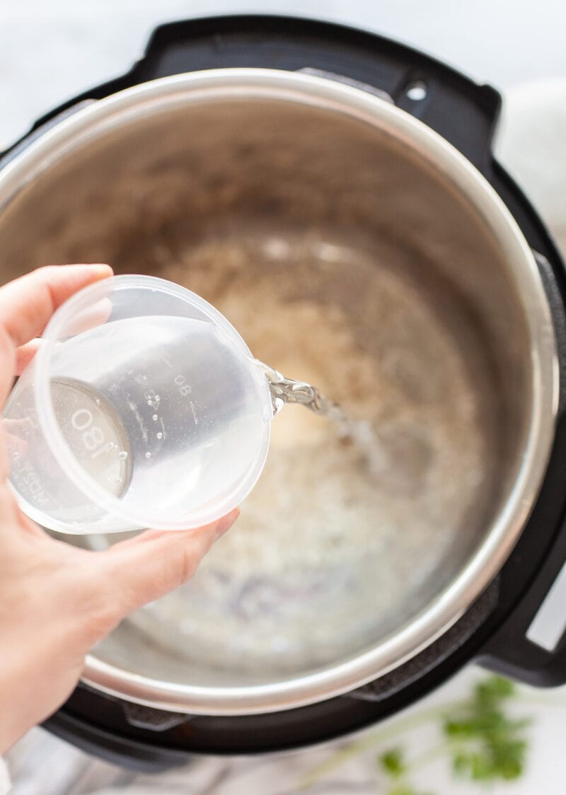 Pouring water into instant pot for Instant Pot Basmati Rice
