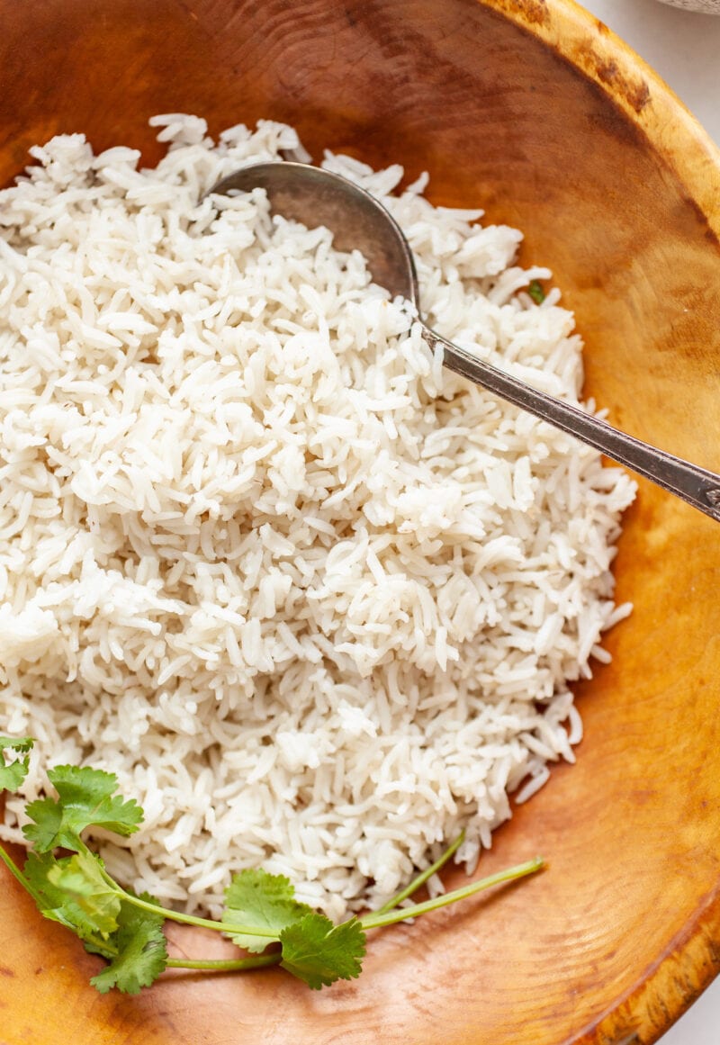 Close up of Instant Pot Basmati Rice in a wood bowl with serving spoon