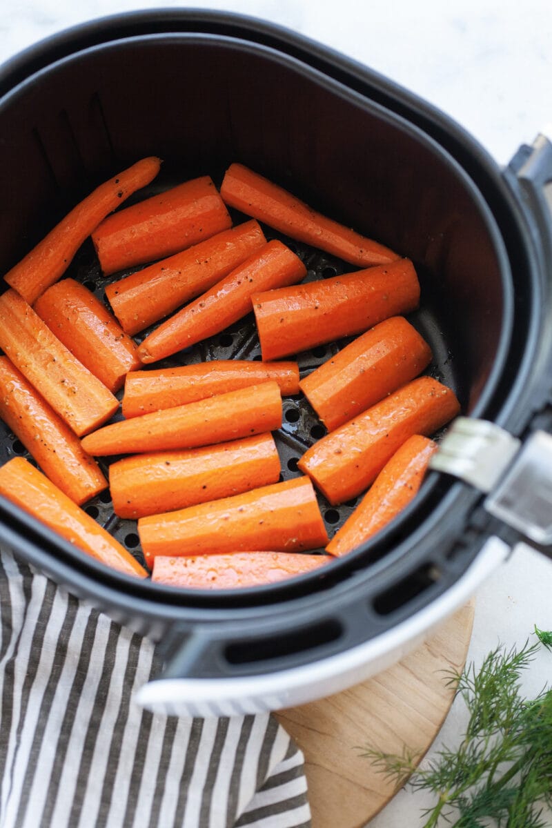 raw carrots in an air fryer basket