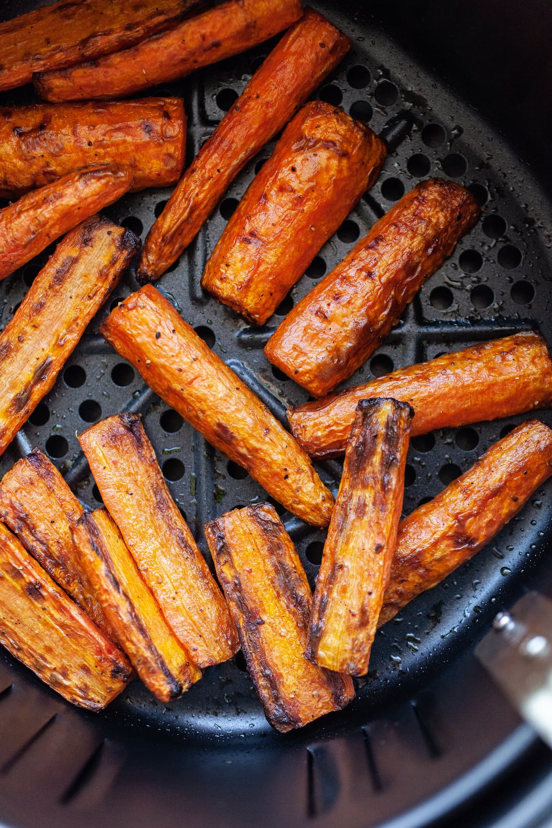 Incredible Air Fryer Carrots in an air fryer basket