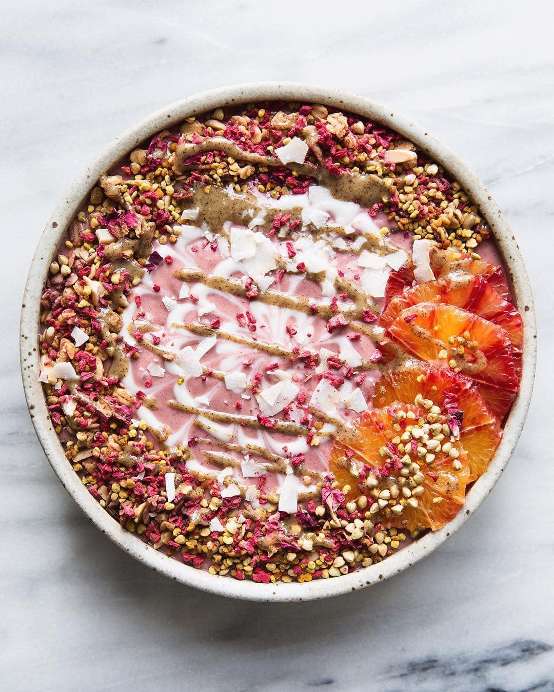Smoothie bowl topped with bee pollen and nut butter