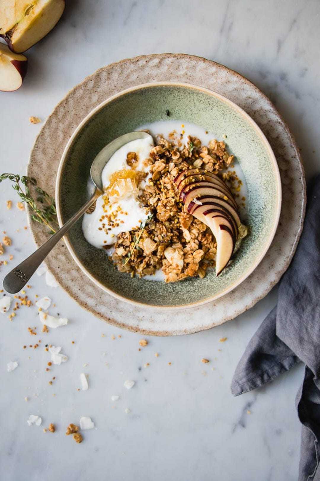 Apple Granola in a green bowl with bee pollen