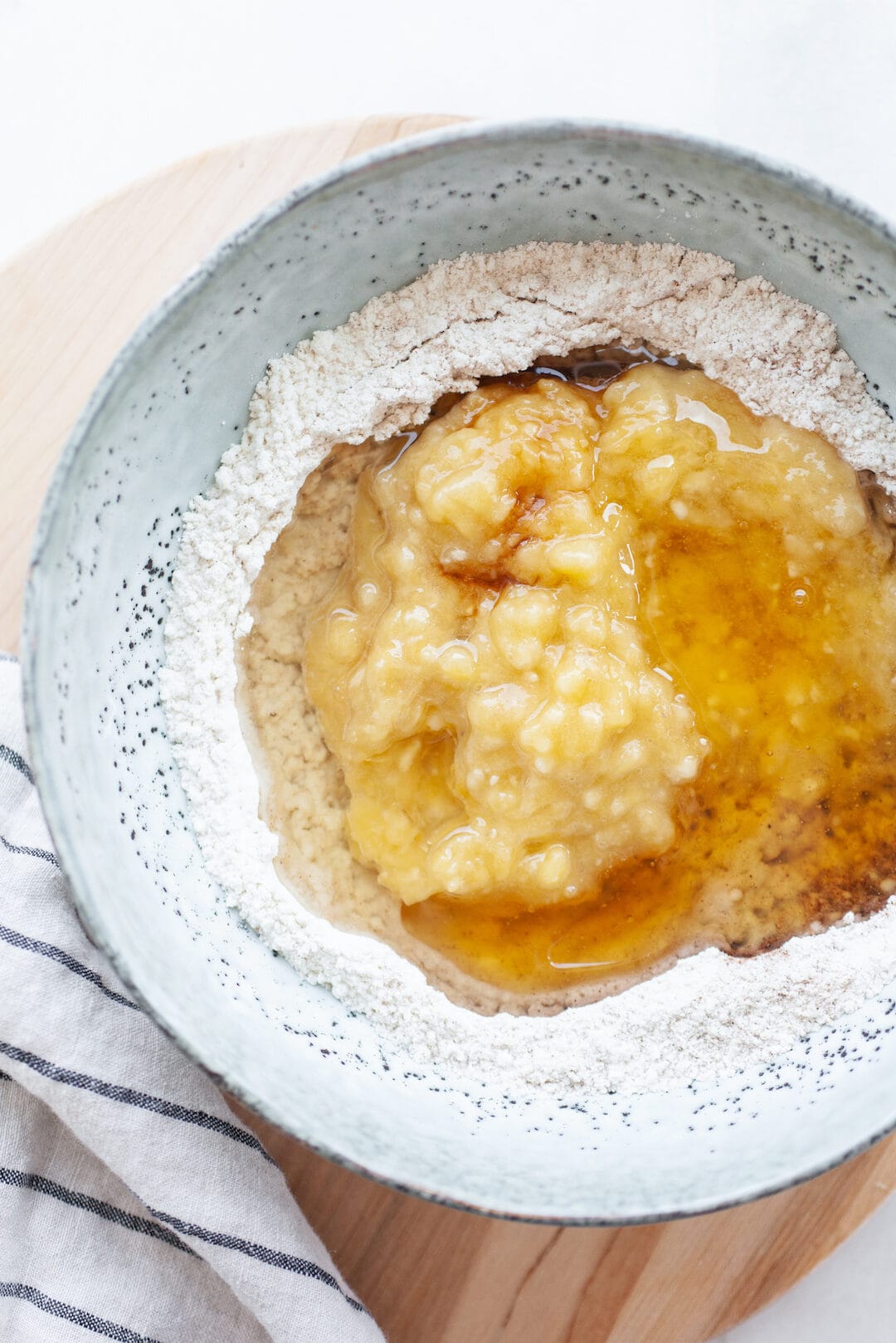 Mashed banana and flour in a bowl for instant pot banana bread
