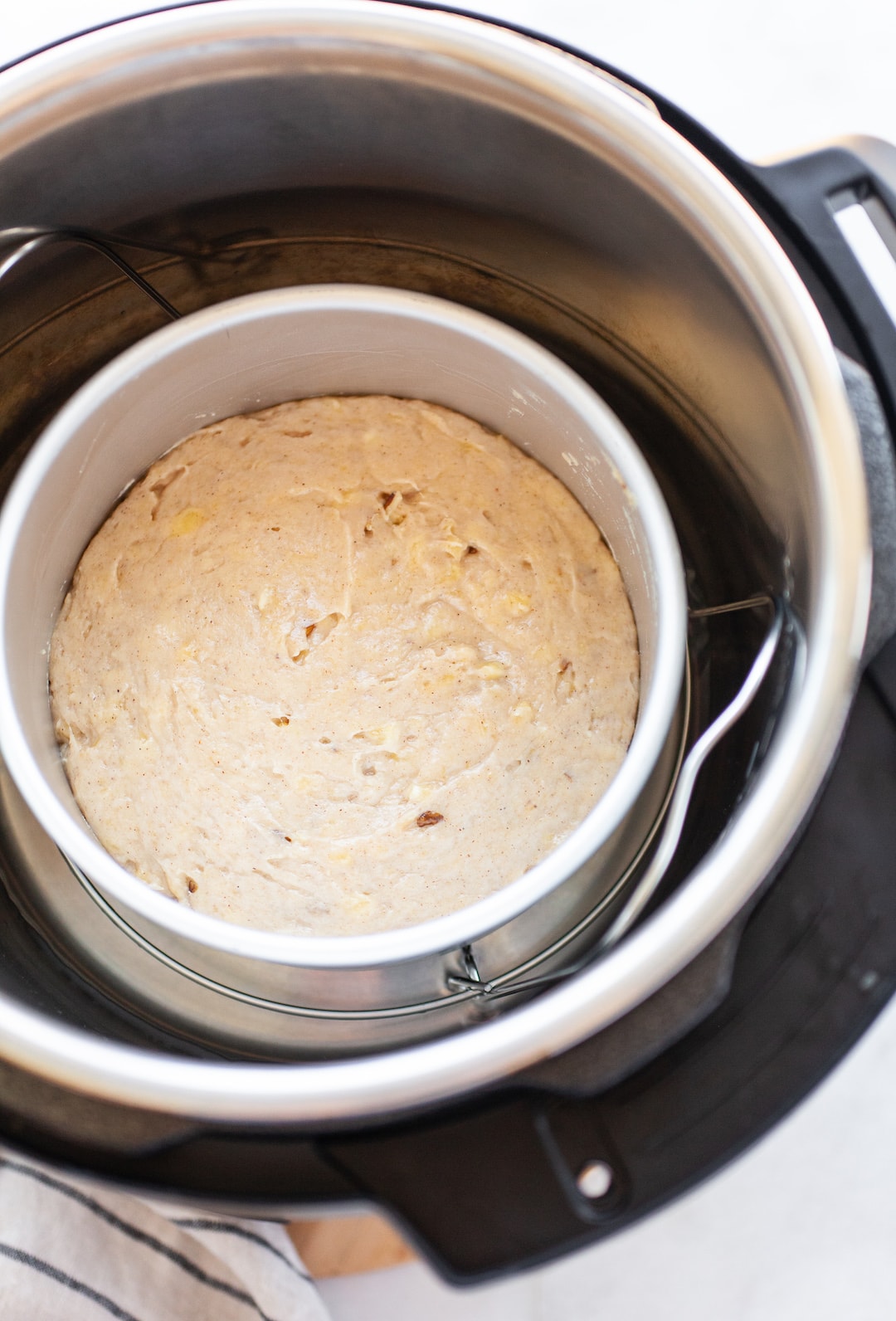 Cake pan sitting inside an instant pot filled with banana bread batter