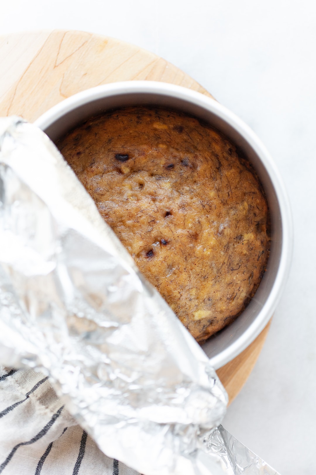Instant Pot Banana Bread in a cake pan with tin foil on the top