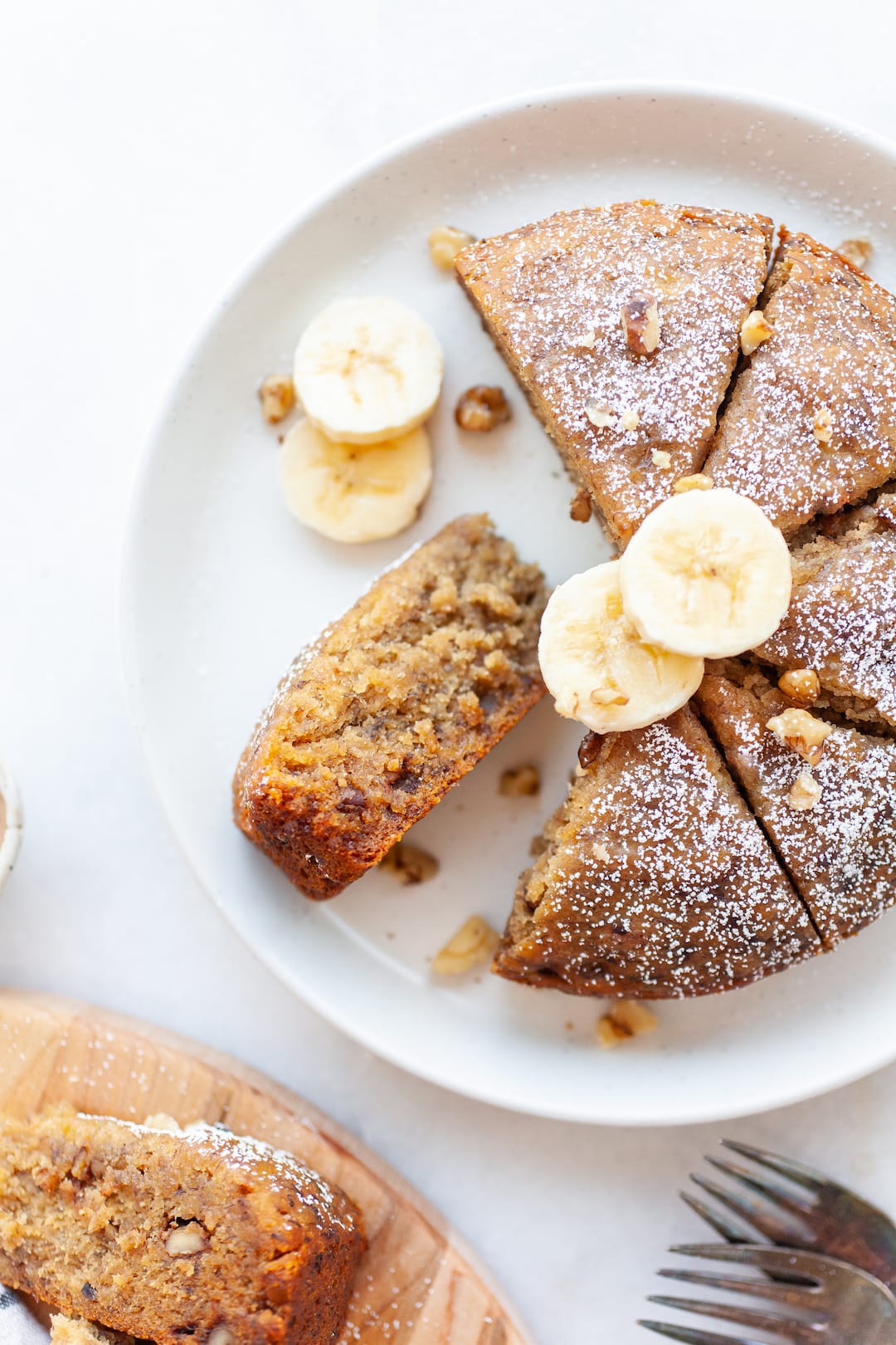 Close up of instant pot banana bread topped with powdered sugar and banana slices
