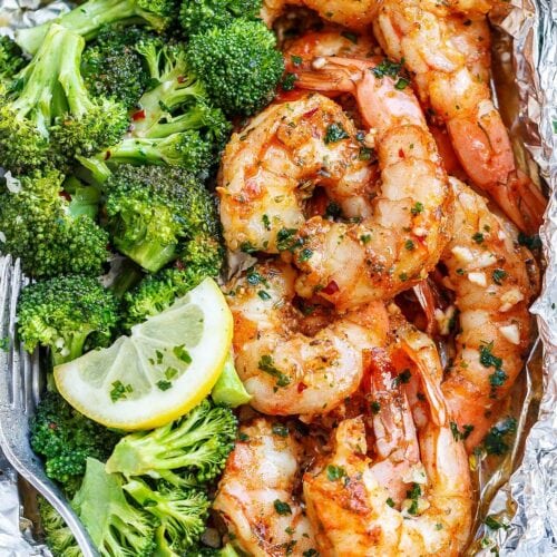 Cooked shrimp and broccoli in a tin foil packet