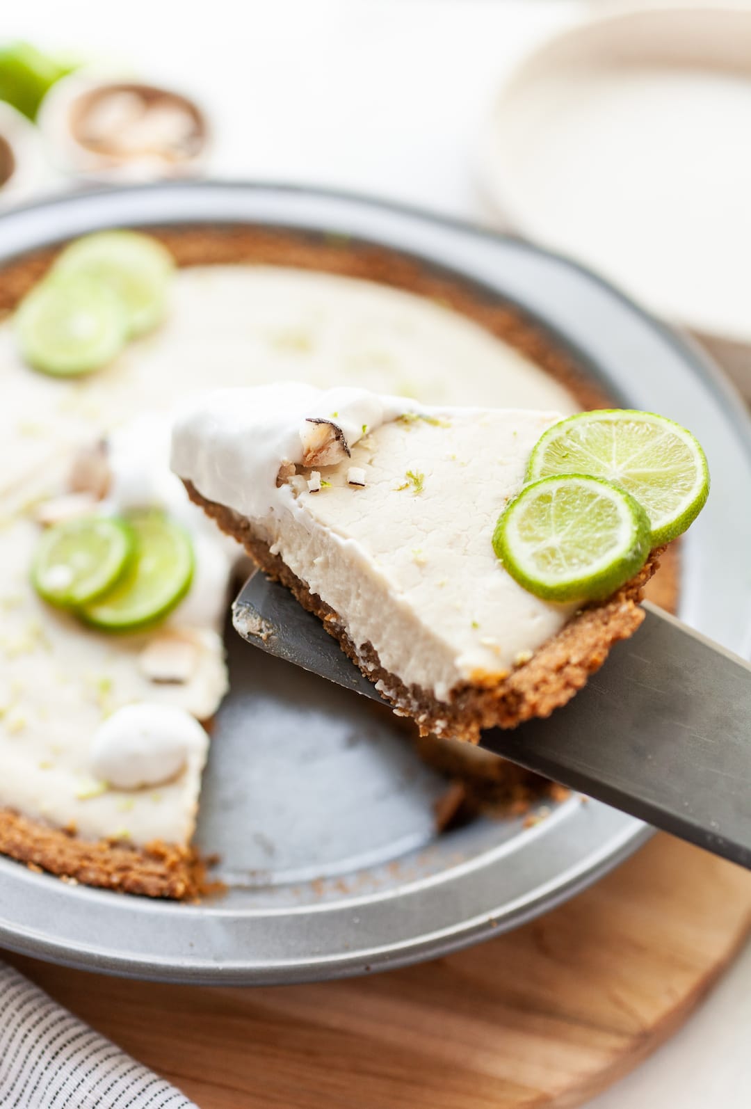 Vegan Key Lime Pie with a slice of pie being lifted out with a spatula
