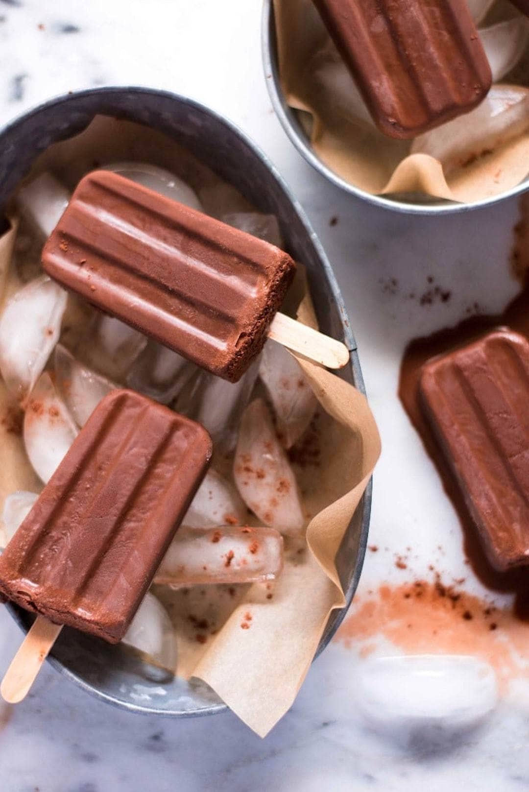 trays of ice topped with 4 ingredient healthy fudgesicles