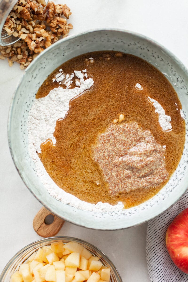 flour and liquid in a bowl for vegan apple cake recipe