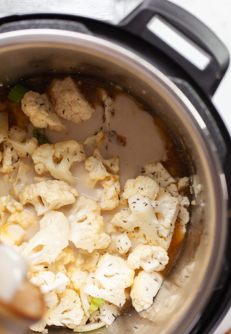 image of cauliflower in an instant pot with broth and milk