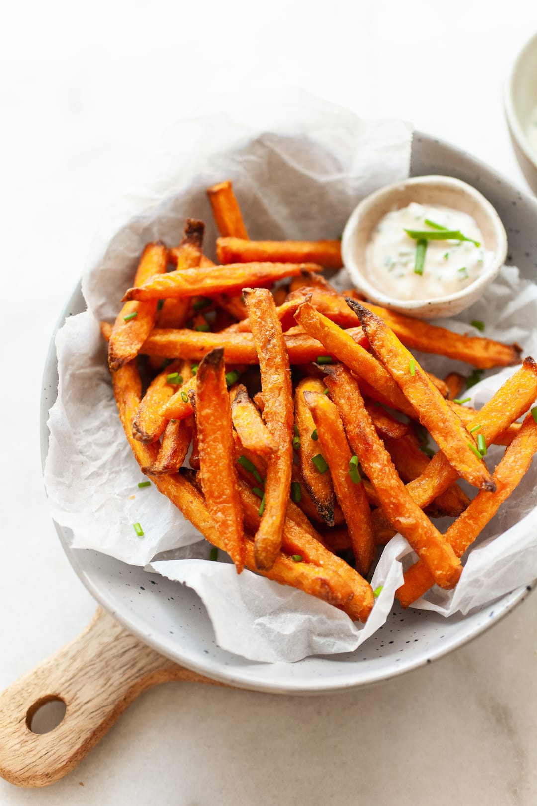 cooked from frozen sweet potato fries in a bowl with aioli dip on the side