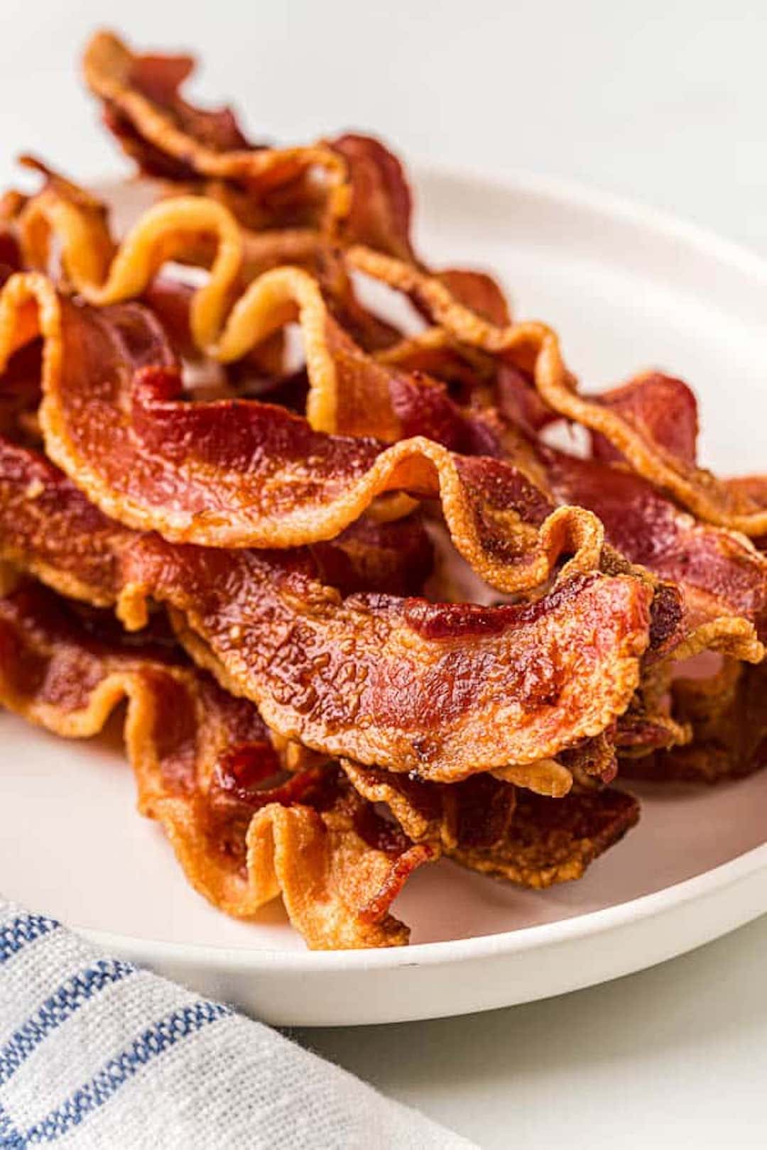 image of air fryer bacon strips on a white plate