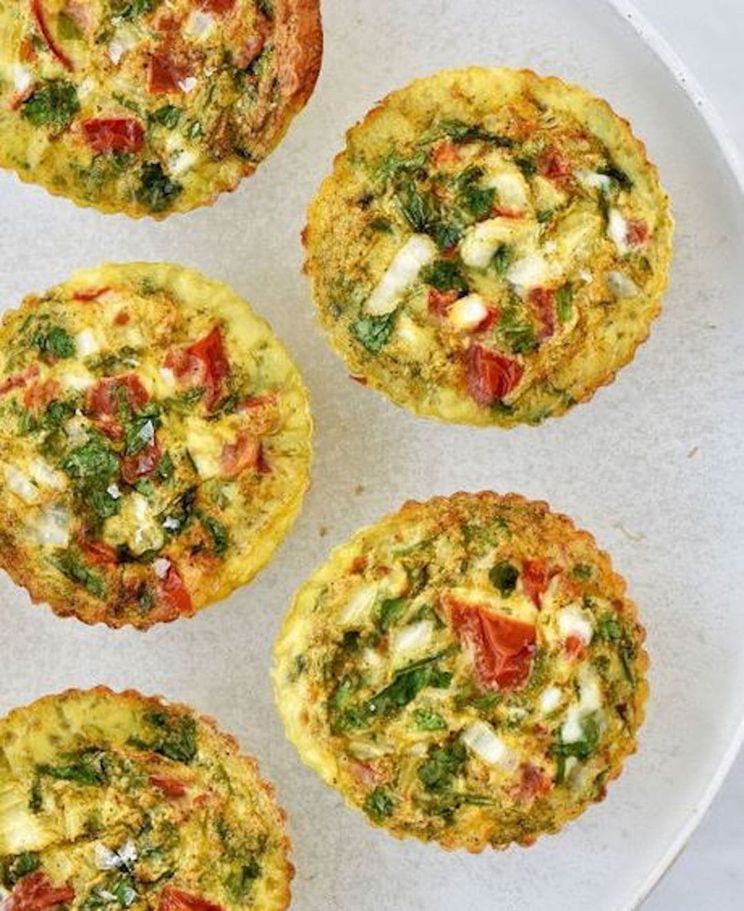 image of a white plate topped with air fryer breakfast egg frittata muffins