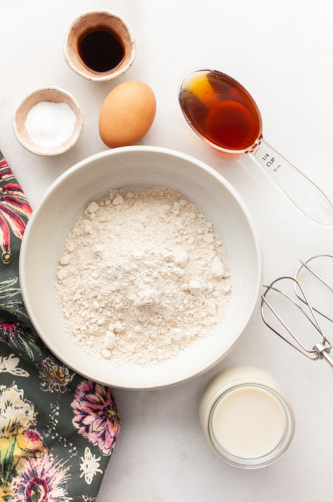 image of ingredients for Fluffy Oat Flour Pancakes in bowls on a white marble board