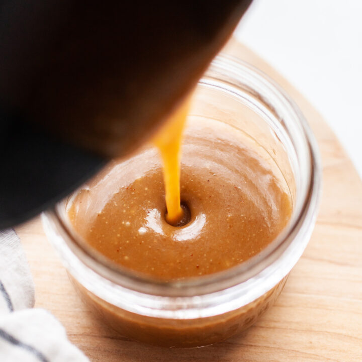 image of a jar of caramel sauce with sauce being poured into the jar